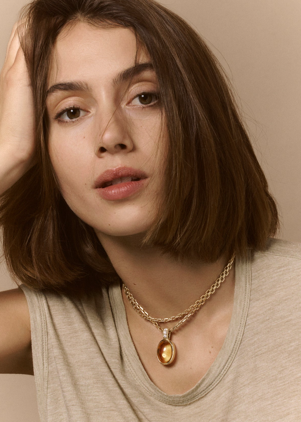 Person wearing Viltier fine jewelry 18k yellow gold diamond Talisman Cabochon Citrine Pendant