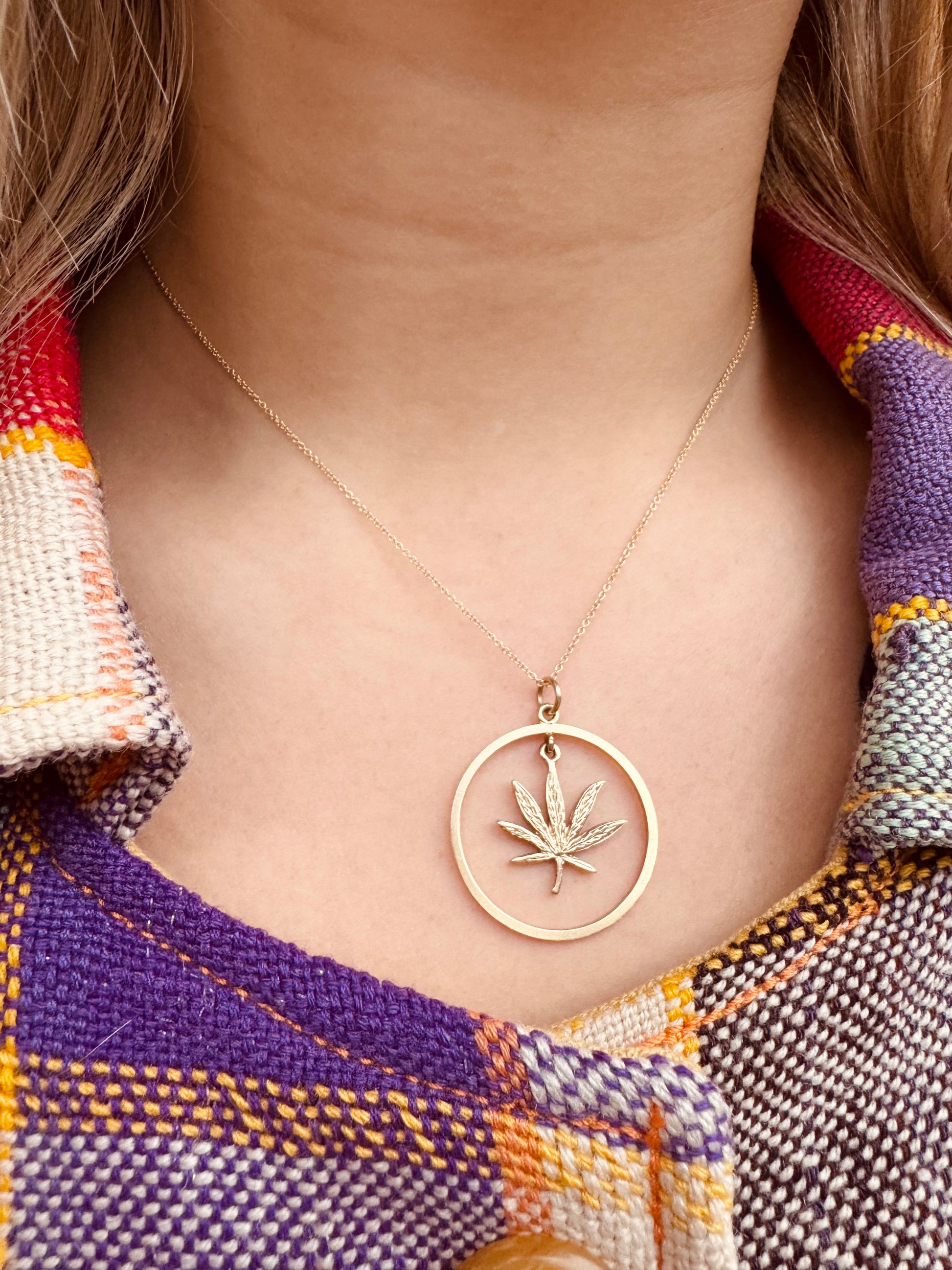 Person wearing Vintage fine jewelry 14k yellow gold Halo Leaf Charm