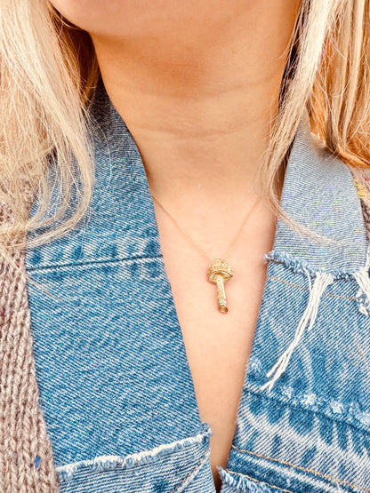 Person wearing Vintage fine jewelry 14k yellow gold Mushroom Charm
