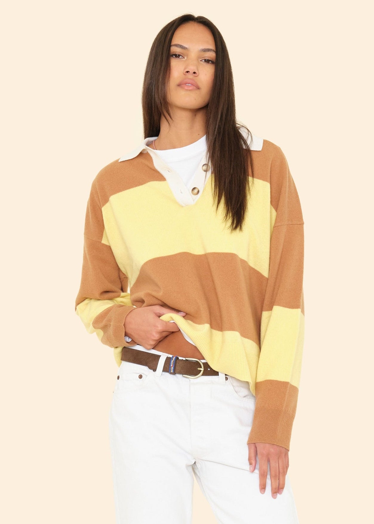 Person wearing Xirena womens Braxton Rugby Polo Sweater in Camel Stripe