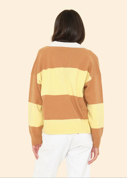 Person wearing Xirena womens Braxton Rugby Polo Sweater in Camel Stripe