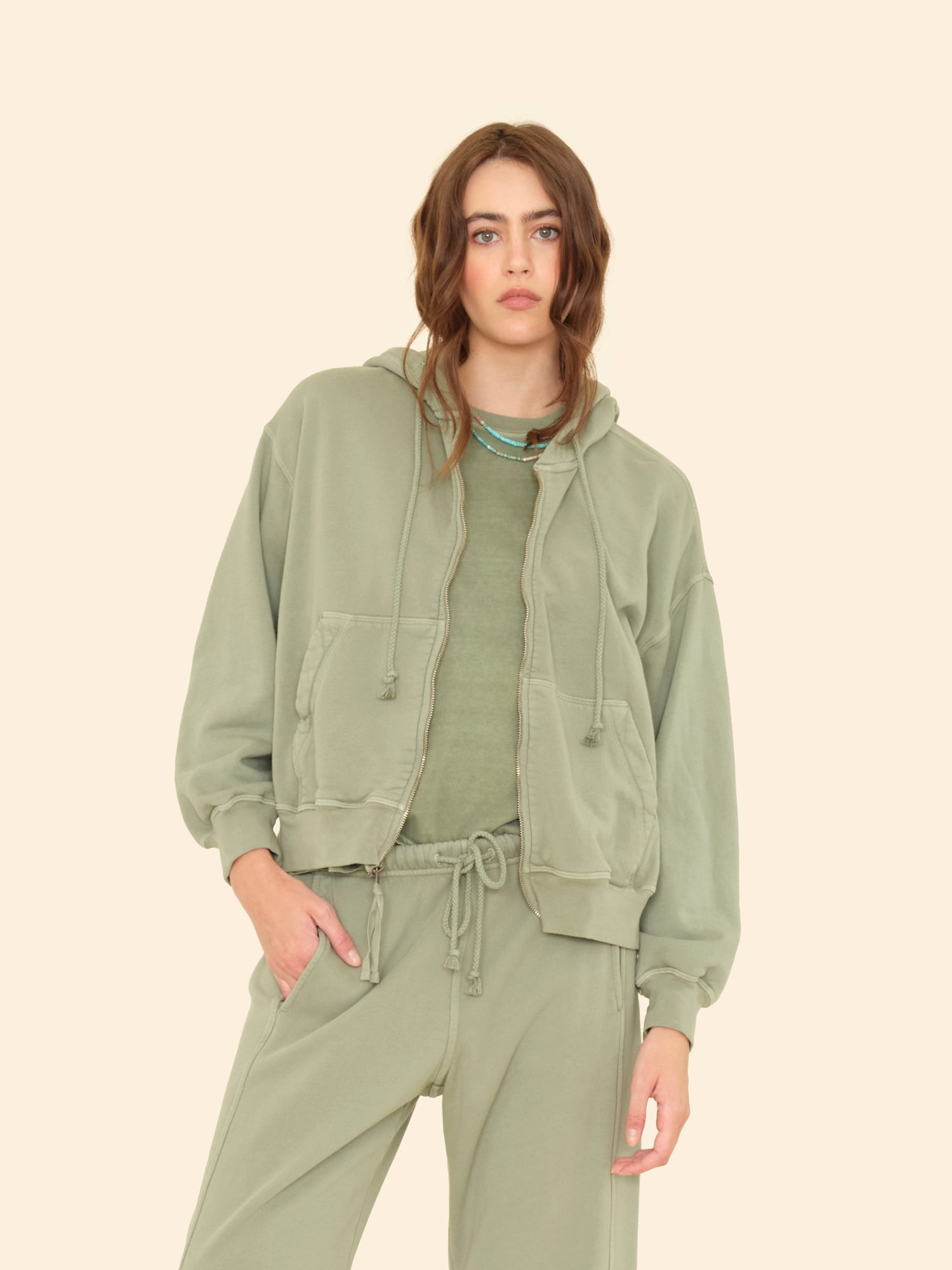 Person wearing Xirena womens Smith Sweatshirt in in Olive Leaf