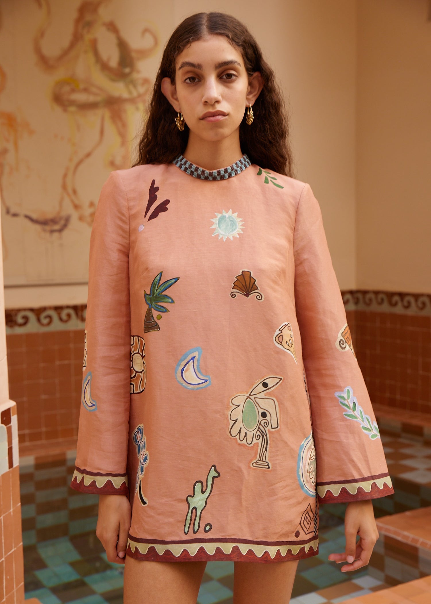 person wearing alemais womens pink printed Laurence Mini Dress