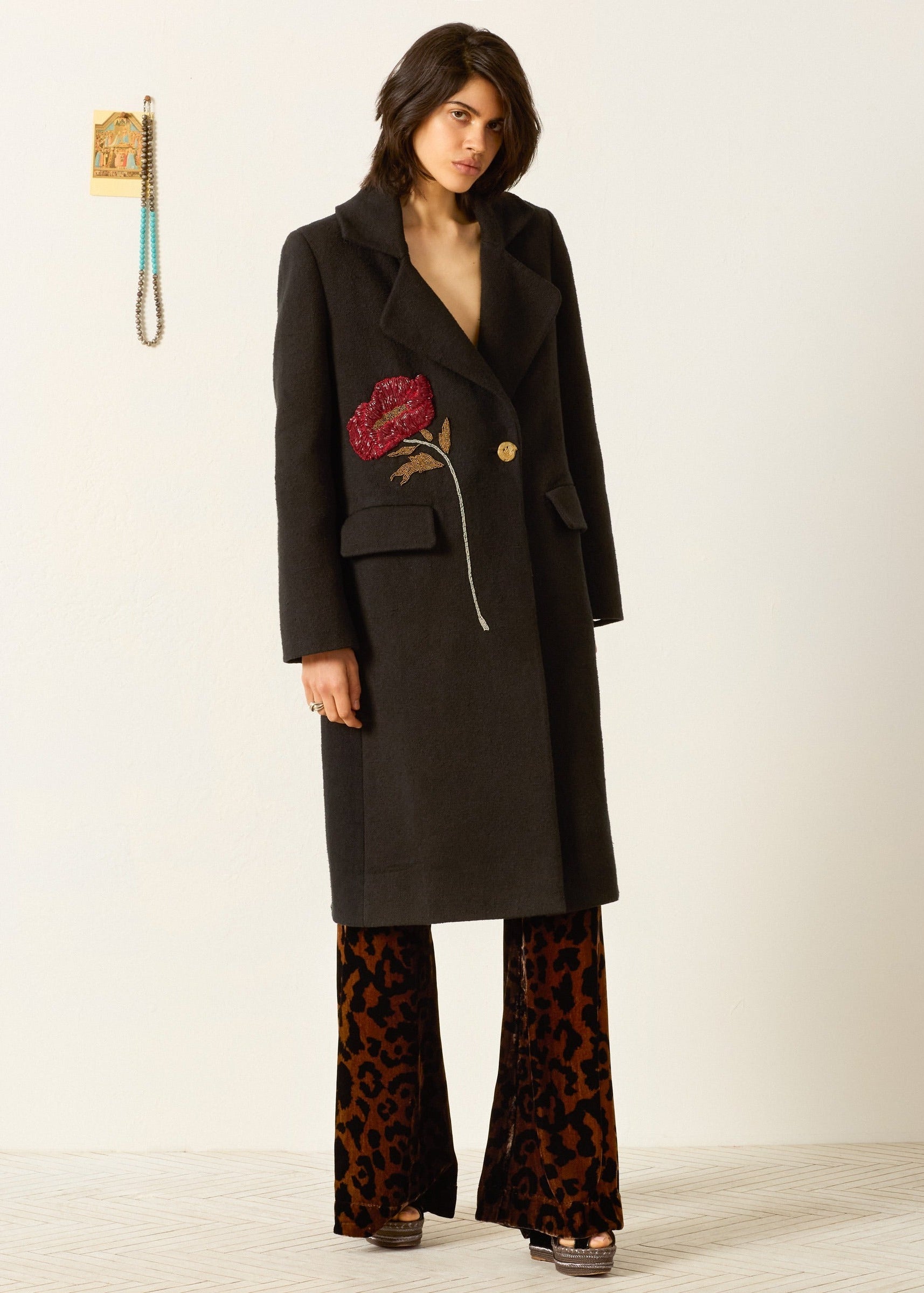 person wearing alix of bohemia beaded Petunia Sangria Poppy Coat