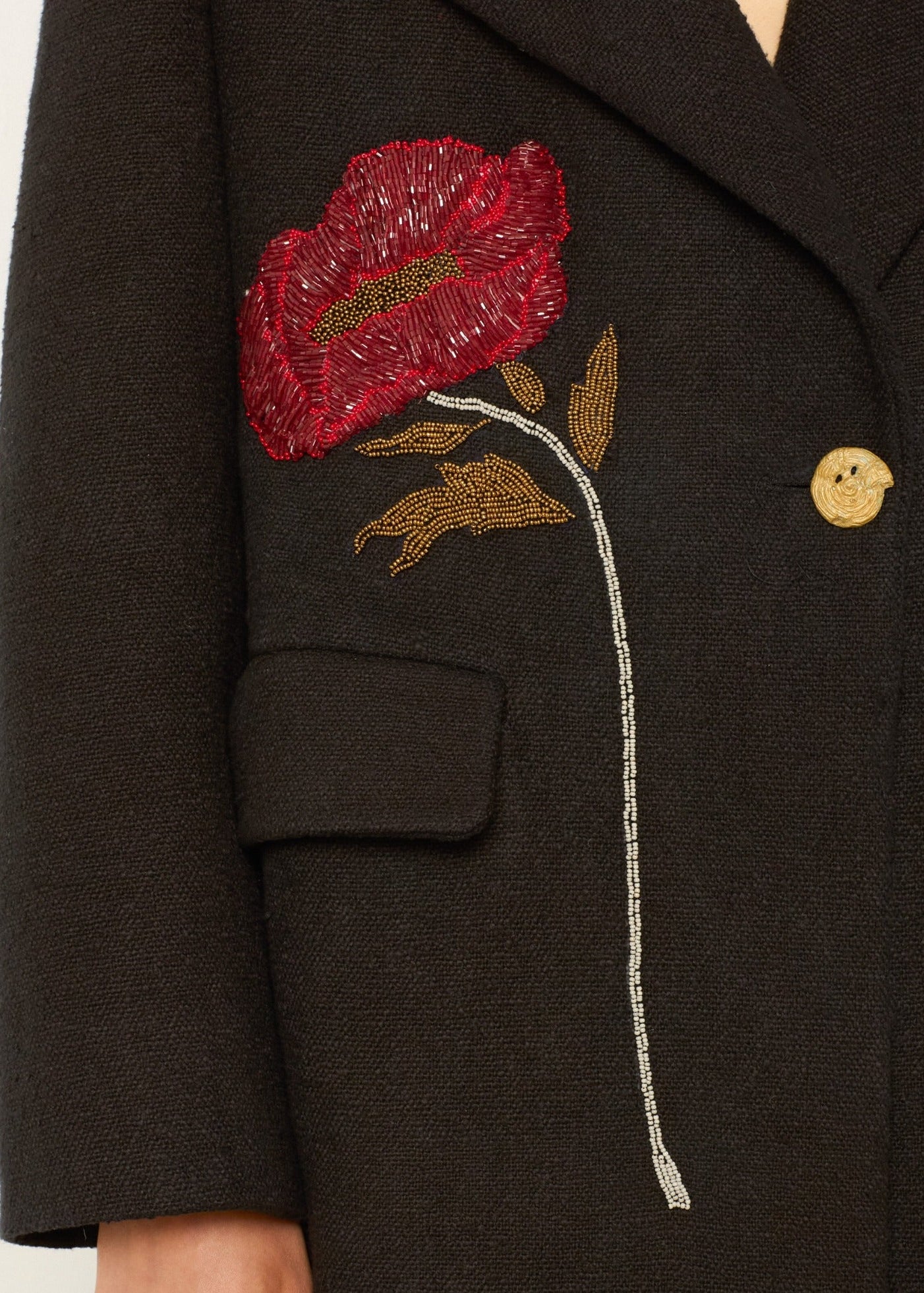 person wearing alix of bohemia beaded Petunia Sangria Poppy Coat