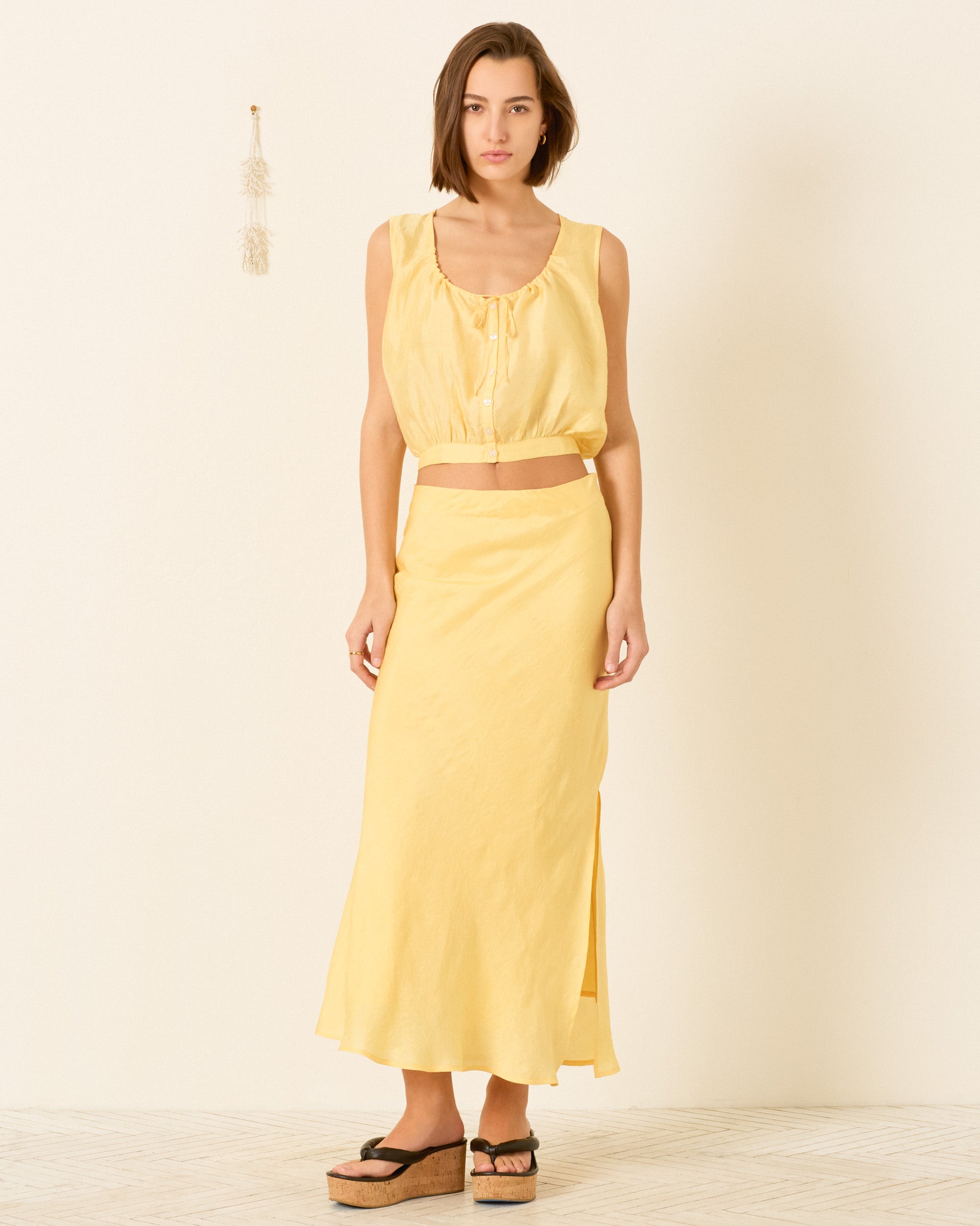 person wearing alix of bohemia womens Nova Sunlight Silk Shirt yellow Lyra Sunlight Silk Skirt