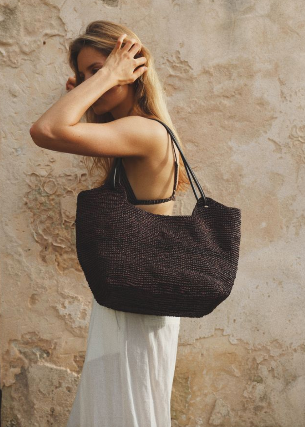person wearing bembien Amaya Raffia Tote in Brown