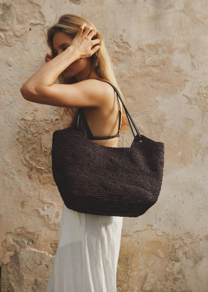 person wearing bembien Amaya Raffia Tote in Brown