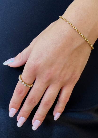 person wearing camille beinhorn fine jewelry 22k yellow gold Handwoven Diamond Chain Bracelet old mine cut diamond eternity band