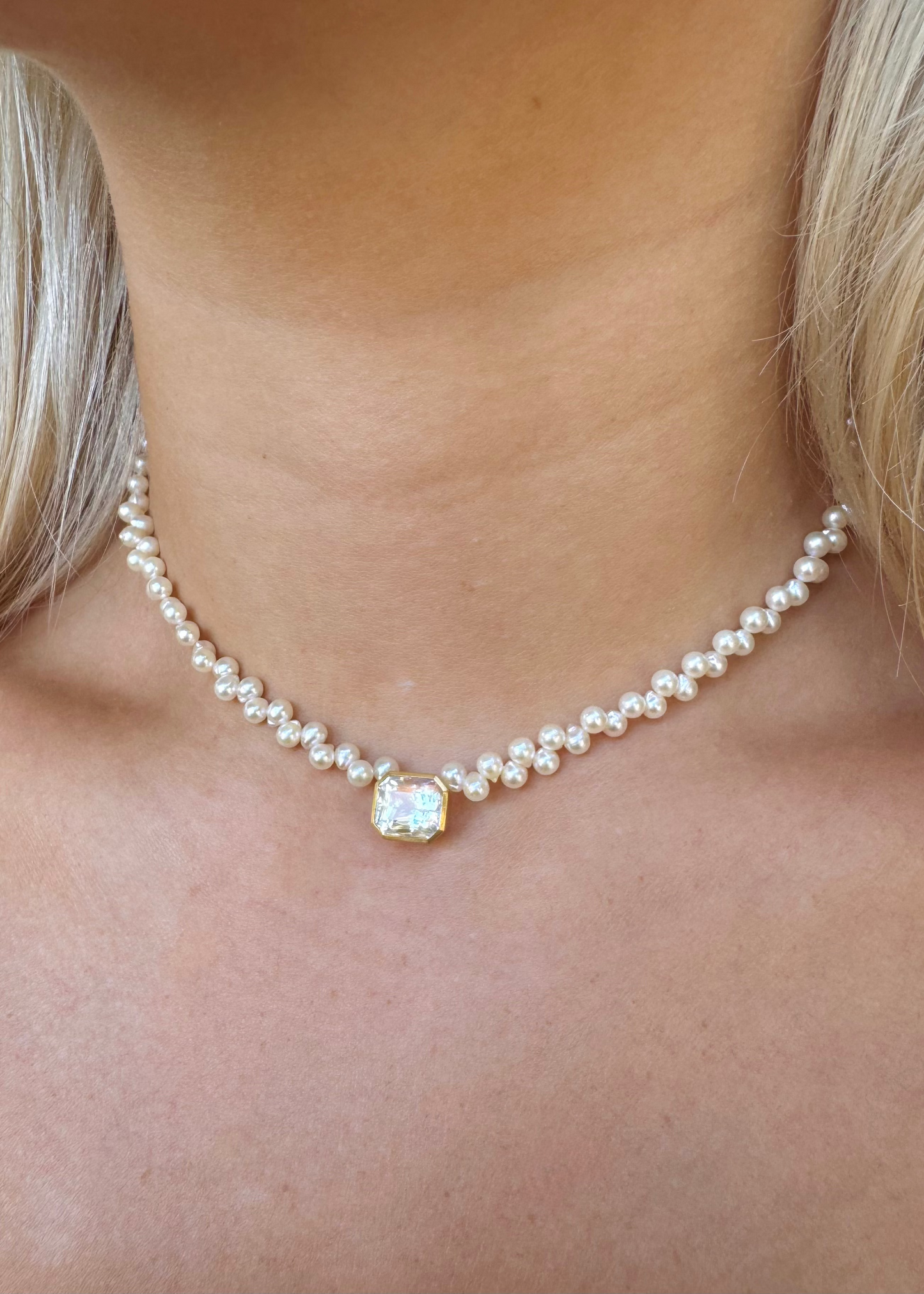 person wearing camille beinhorn fine jewelry 22k yellow gold Rainbow Moonstone & Akoya Pearl Rosette Collar