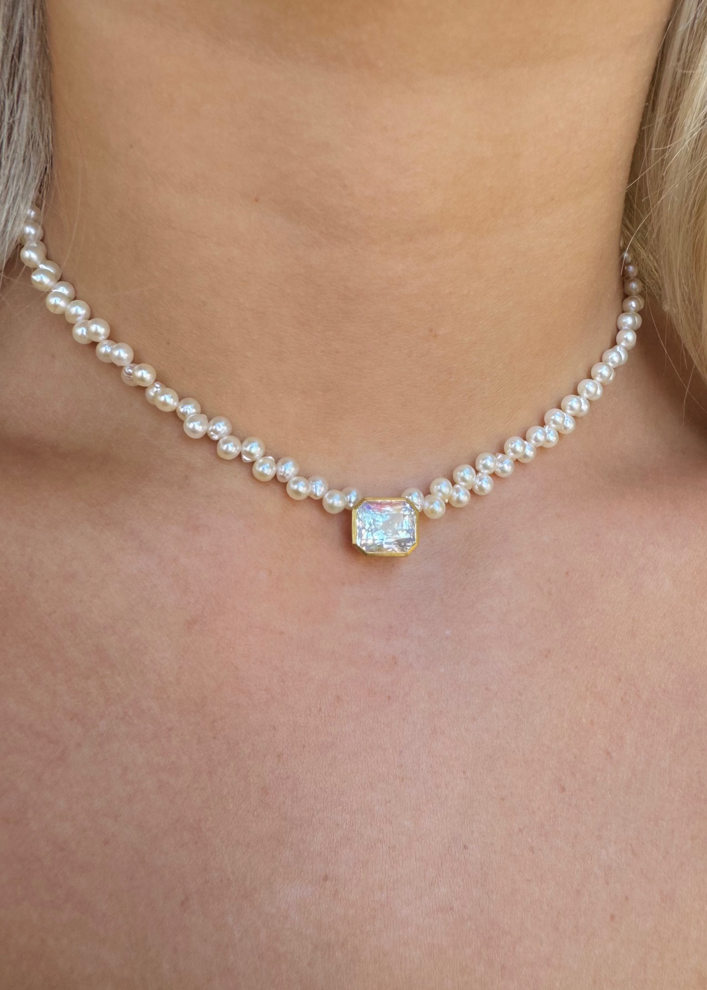 person wearing camille beinhorn fine jewelry 22k yellow gold Rainbow Moonstone & Akoya Pearl Rosette Collar