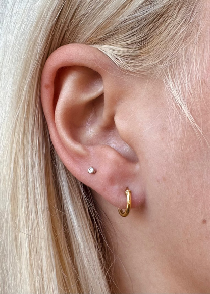 person wearing camille beinhorn fine jewelry 22k yellow gold Signature Mini Hoop 6mm Earrings