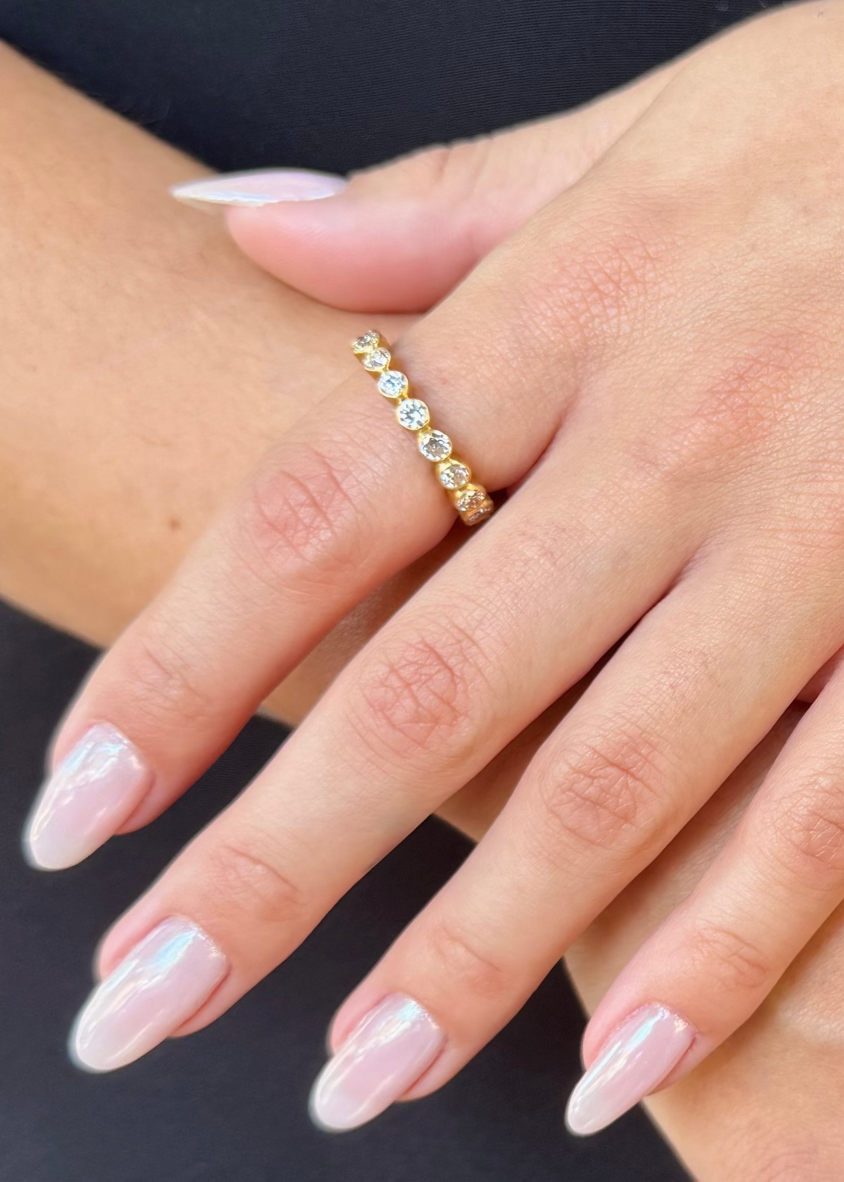 person wearing camille beinhorn fine jewelry 22k yellow gold old mine cut diamond Infiniti eternity Band