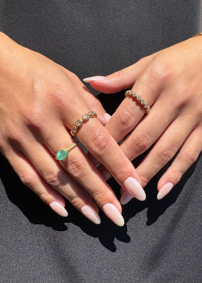 person wearing camille beinhorn fine jewelry 22k yellow gold old mine cut diamond champagne diamond Infiniti eternity Band one of a kind pariaba tourmaline bezel ring