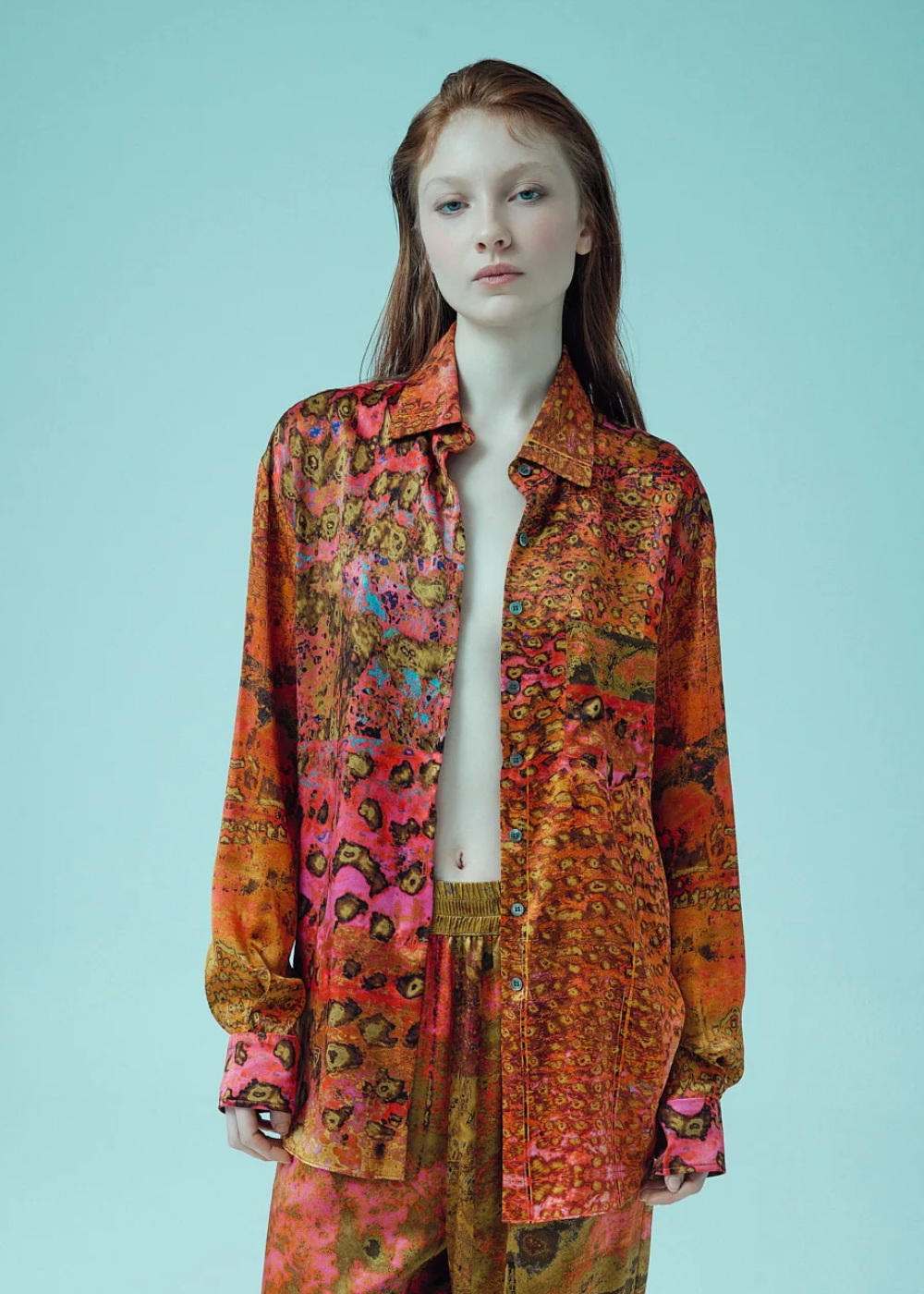 person wearing carmen molina womens printed silk Button Down Boyfriend Shirt pink leopard