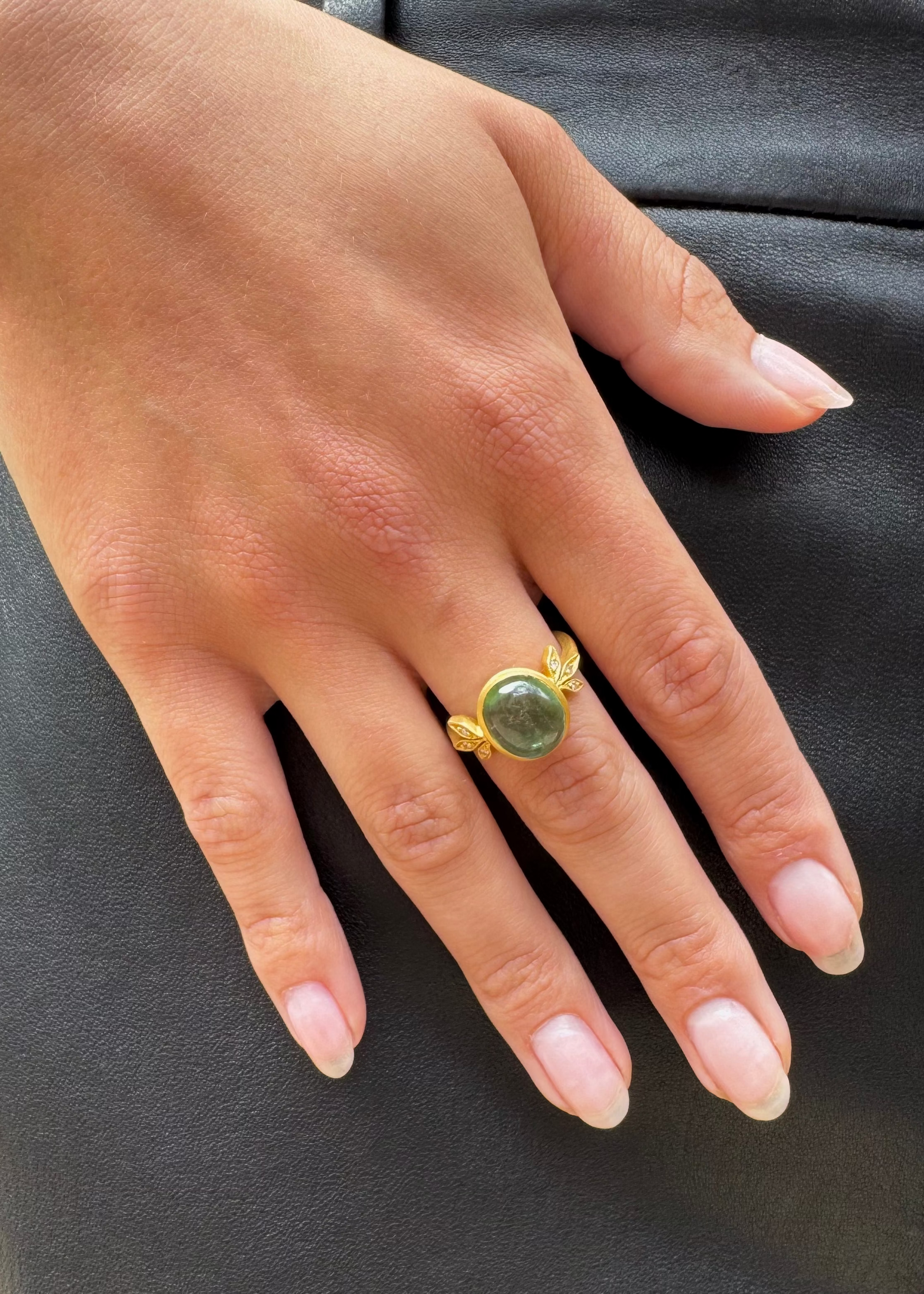 person wearing cathy waterman fine jewelry 22k yellow gold Moderne Ring with Green Tourmaline