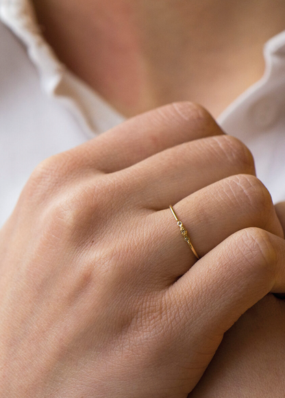 person wearing celine daoust fine jewelry 14k yellow gold mini Diamond Eye Ring