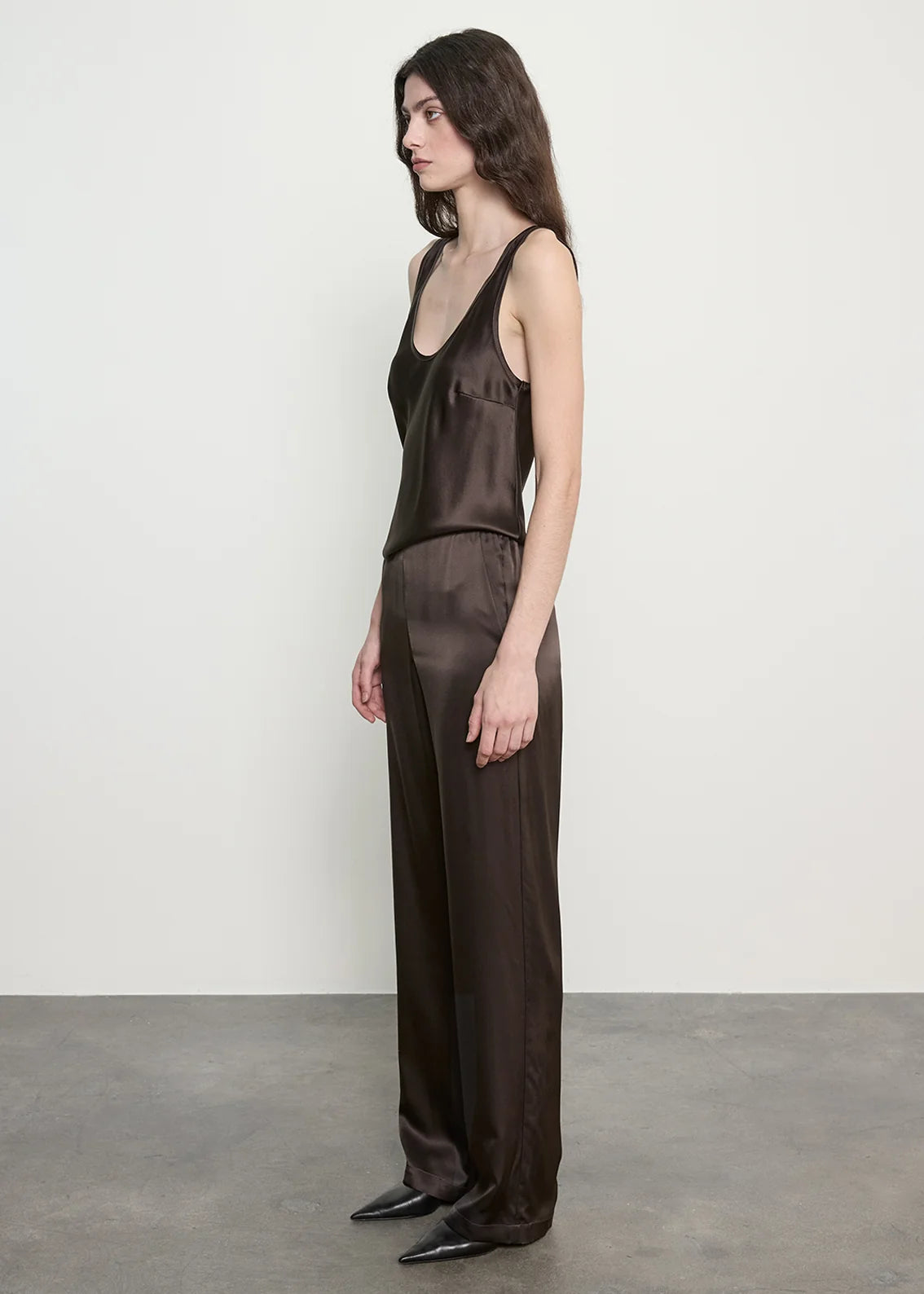 person wearing enza costa Silk Satin Everywhere Pant in Olive Bronze
