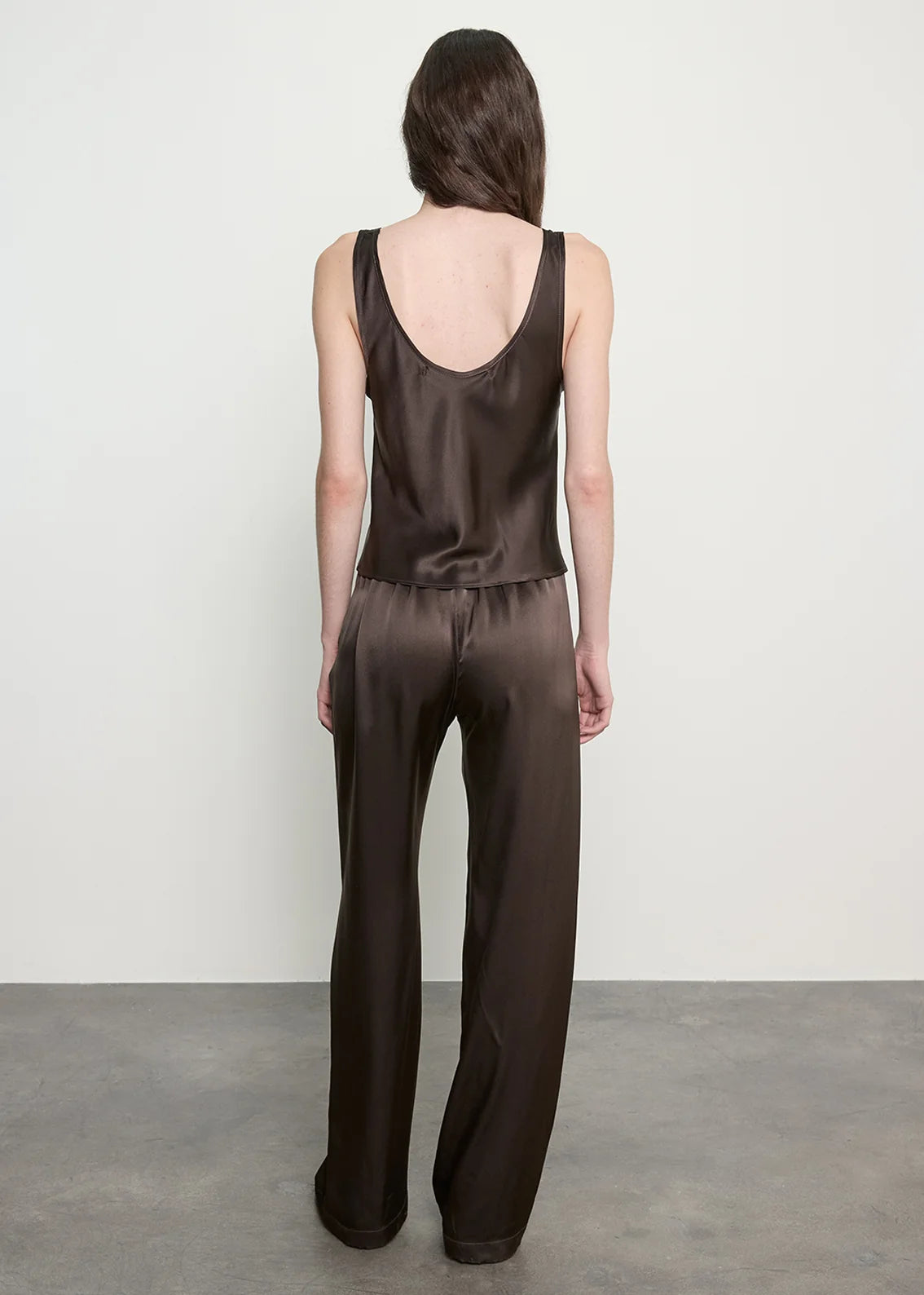 person wearing enza costa Silk Satin Everywhere Pant in Olive Bronze