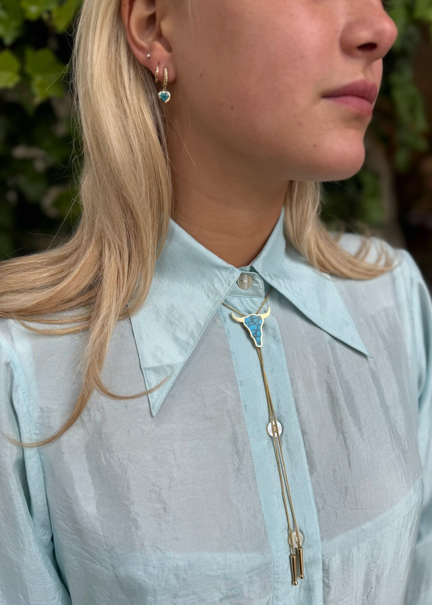 person wearing established jewelry Bull Head Bolo Tie Necklace with Turquoise