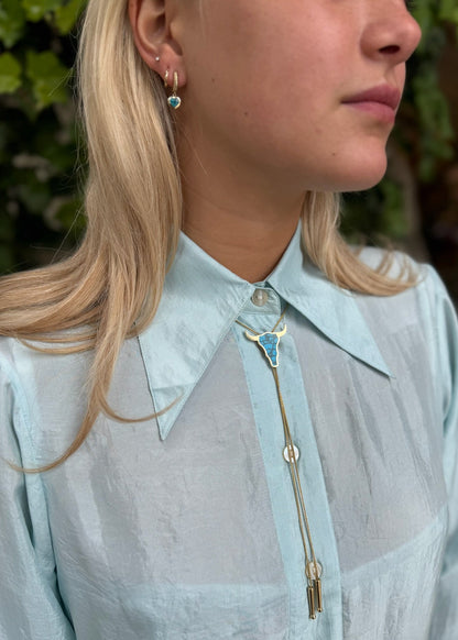 person wearing established jewelry Bull Head Bolo Tie Necklace with Turquoise