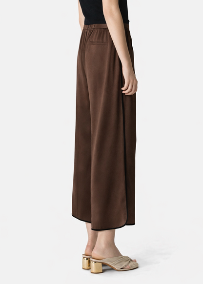 person wearing forte forte Cropped Trousers in Chocolate Envers Satin