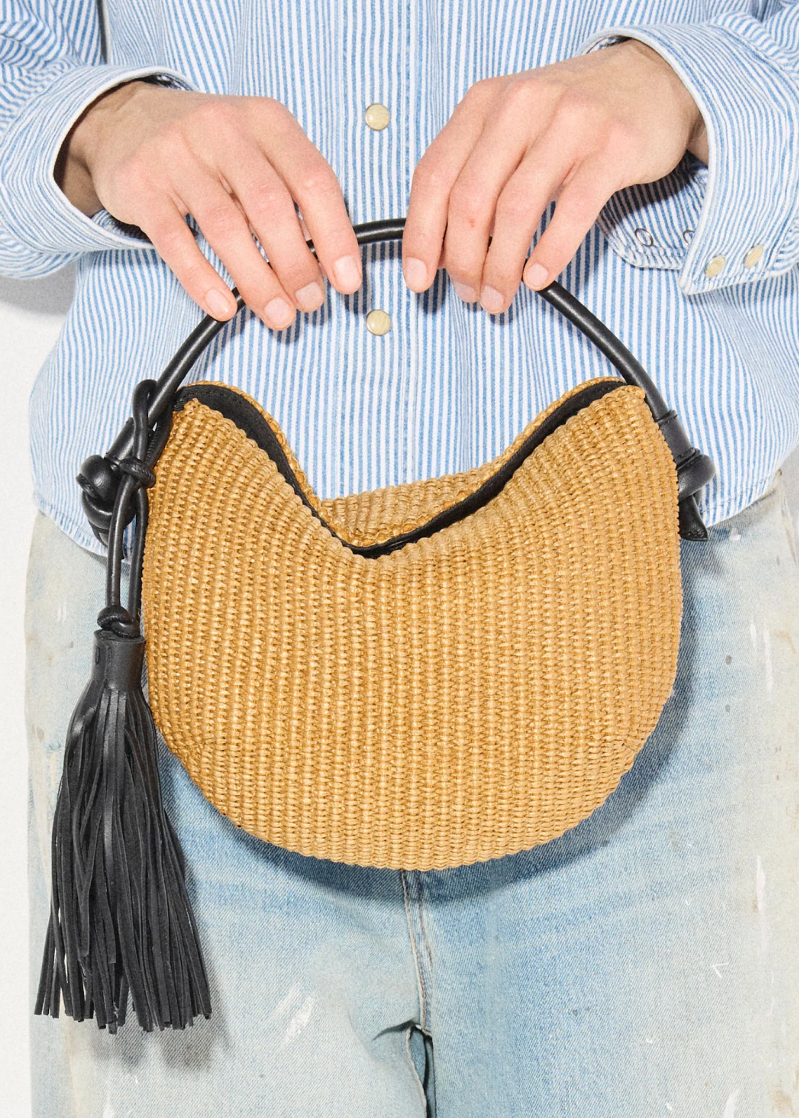 person carrying freda salvador Elis Mini Crescent Bag in Biscuit Raffia