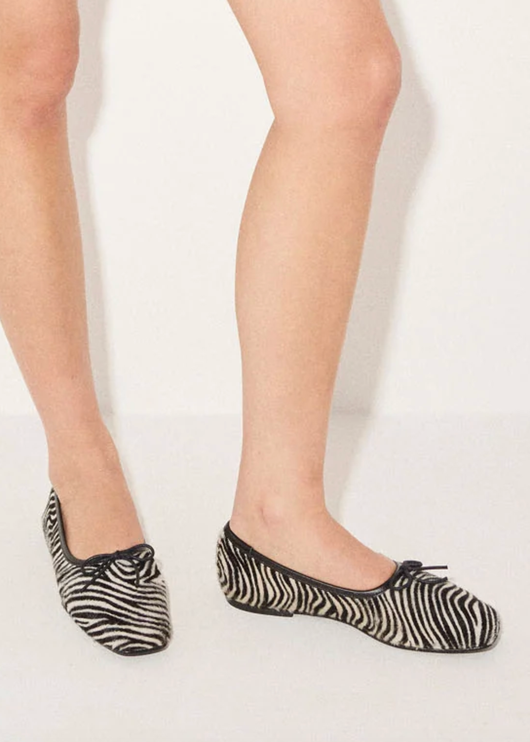 person wearing freda salvador womens Jada Square Toe Ballet Flat in Zebra pony hair