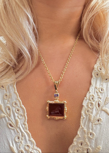 person wearing howl fine jewelry 18k yellow gold Tembo Lion Venetian Glass Pendant amber with tanzanite