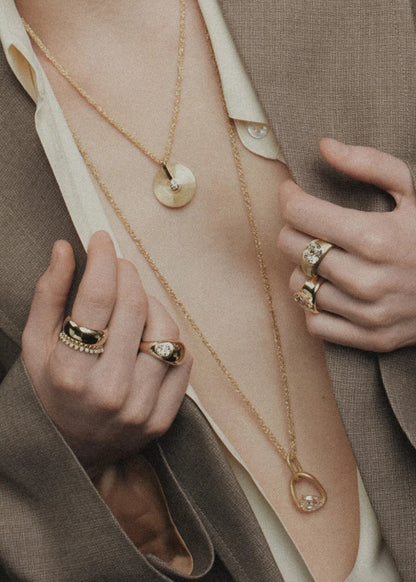 person wearing jade ruzzo fine jewelry  qchains rings pendants