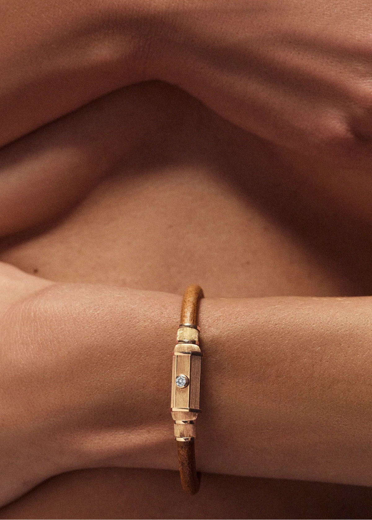 person wearing marie lichtenberg fine jewelry 18k yellow gold Lasso Locket Bracelet diamond