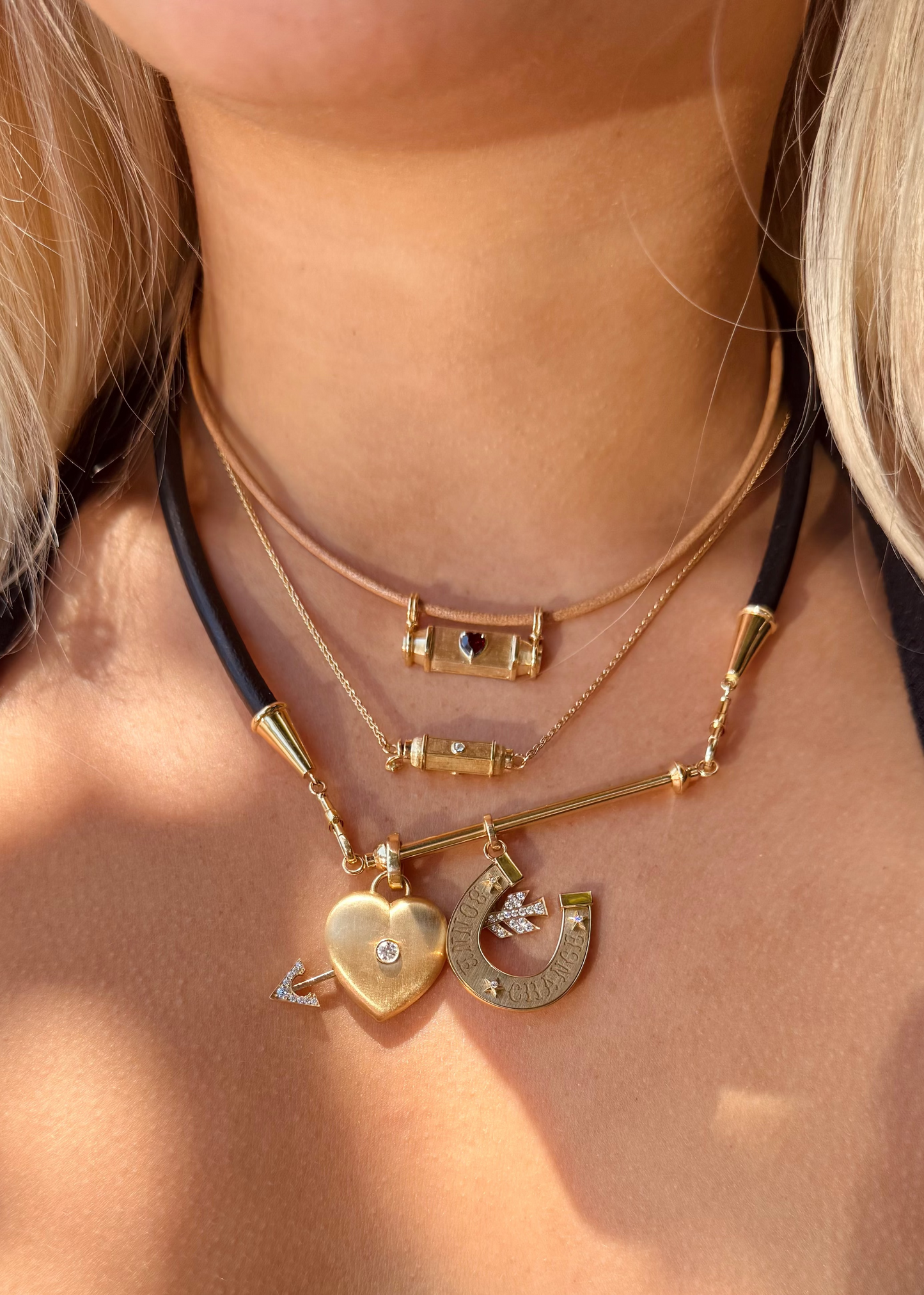 person wearing marie lichtenberg fine jewelry 18k yellow gold necklaces