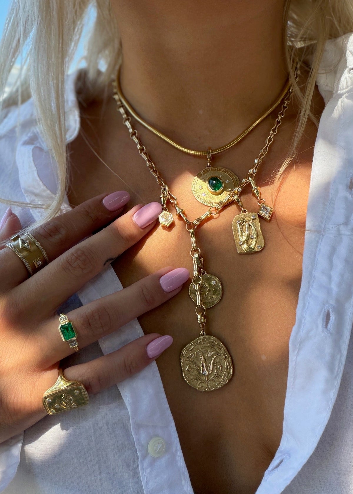 person wearing new arrivals fine jewelry azlee 18k yellow gold emerald diamonds charm necklaces rings