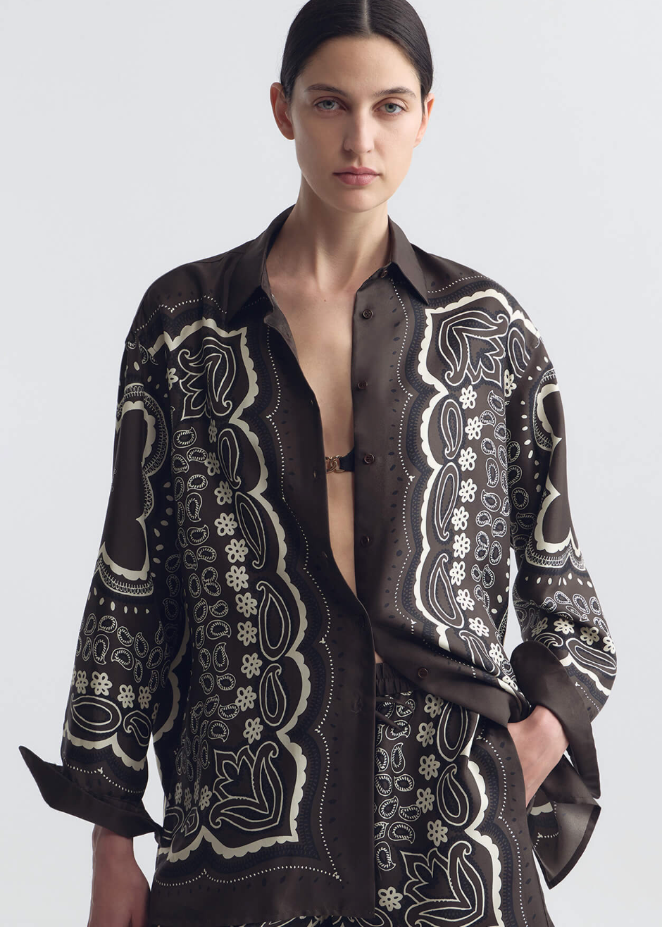 person wearing nili lotan womens Alfie Silk Shirt in Brown ivory bandana print