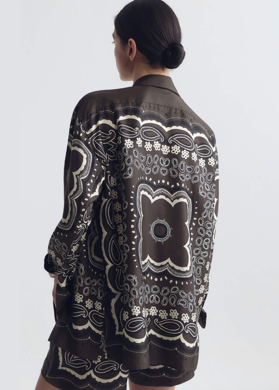person wearing nili lotan womens Alfie Silk Shirt in Brown ivory bandana print