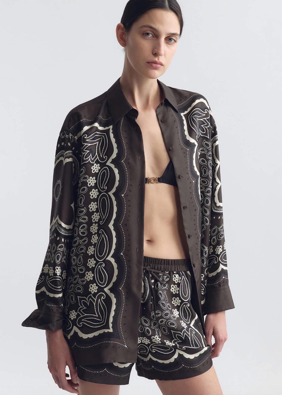 person wearing nili lotan womens Alfie Silk Shirt FRANCES SILK SHORT in Brown ivory bandana print