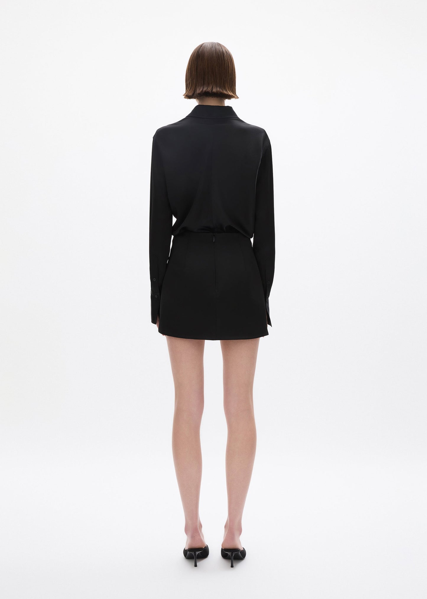 person wearing rachel gilbert satin Hallie Mini Skirt in Black 2