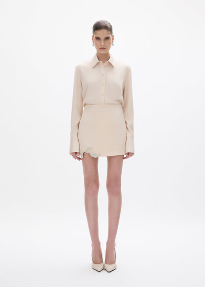 person wearing rachel gilbert satin Hallie Mini Skirt in Champagne
