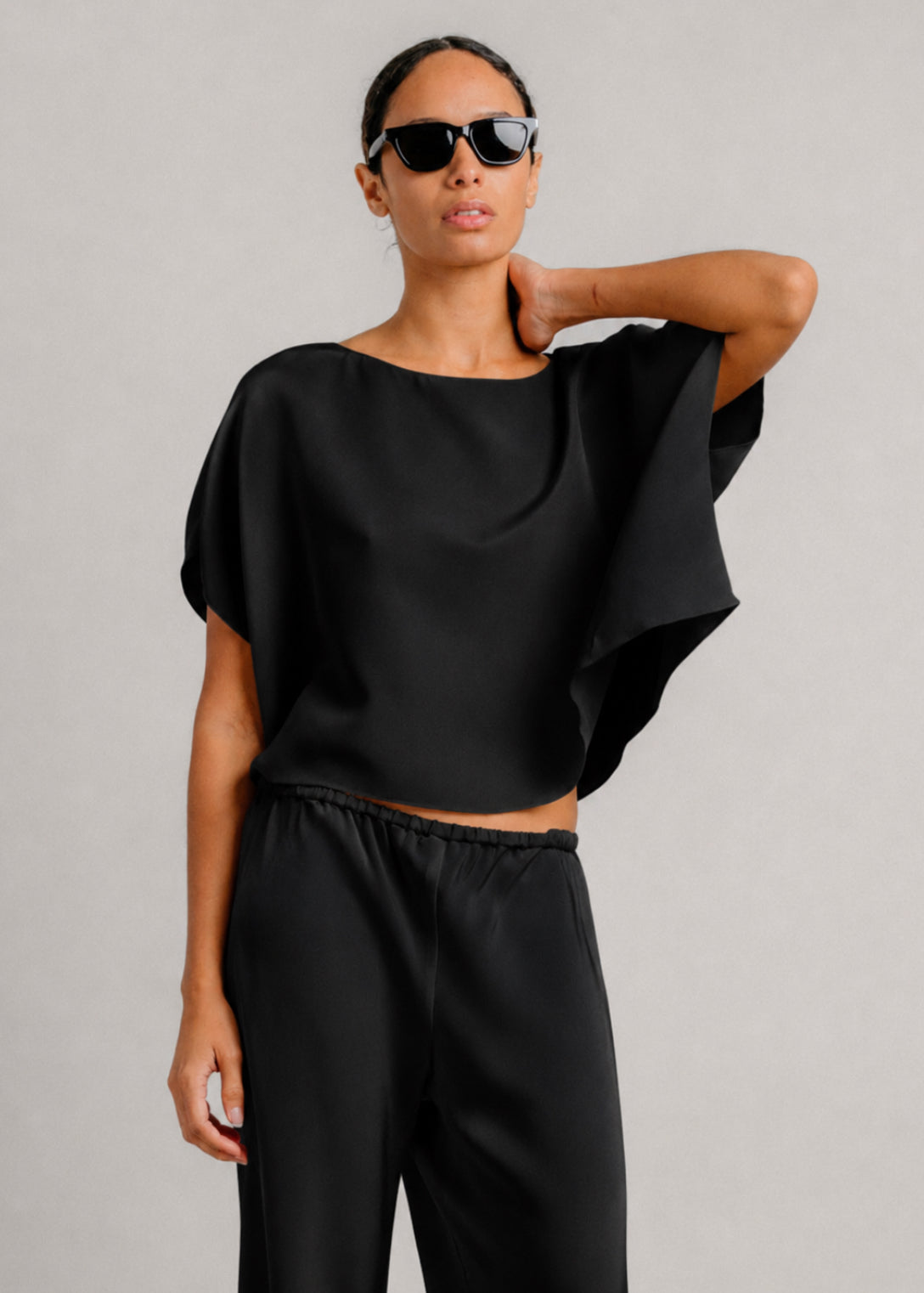 person wearing sablyn womens Kaia Dolman Sleeve Shirt in Black
