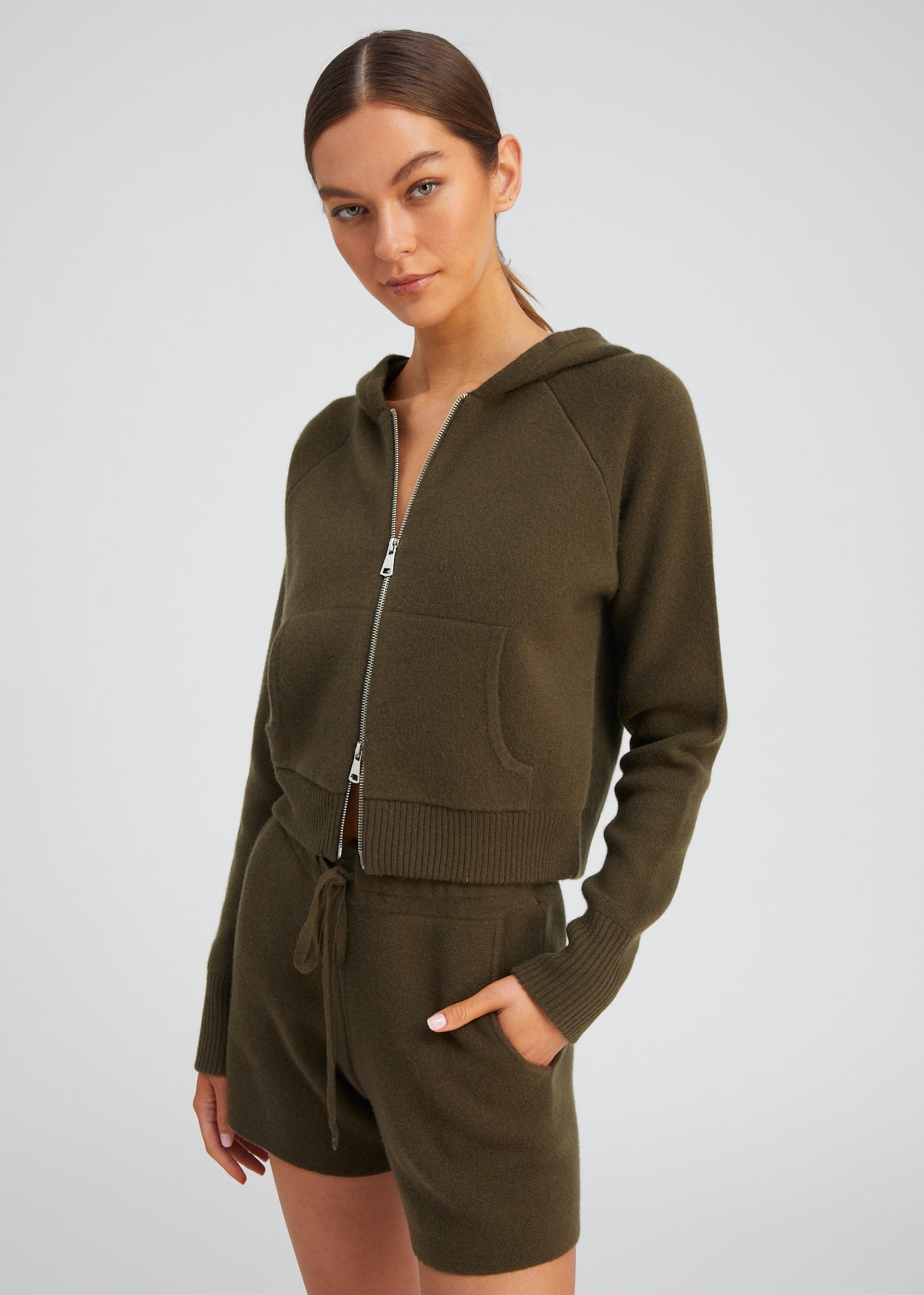 person wearing sablyn womens Shrunken Raglan Cashmere Hoodie in Olive