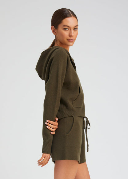 person wearing sablyn womens Shrunken Raglan Cashmere Hoodie in Olive