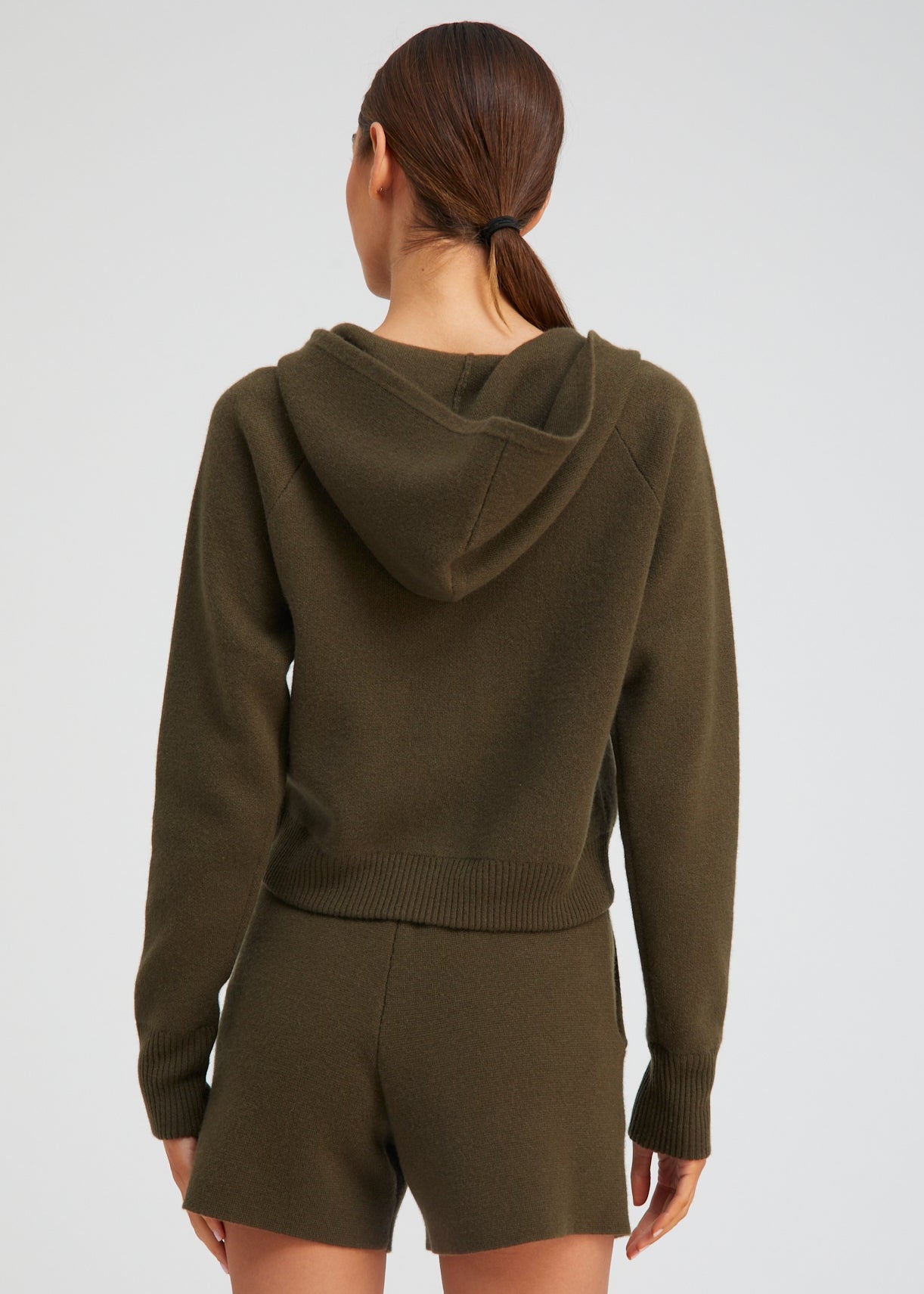 person wearing sablyn womens Shrunken Raglan Cashmere Hoodie in Olive