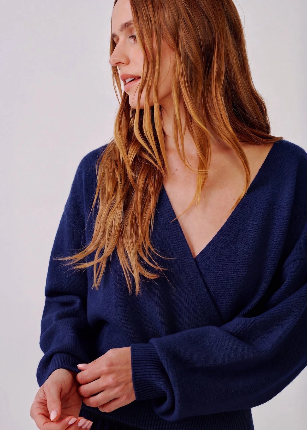 person wearing sablyn womens cashmere Koda Wrap Cashmere Sweater in Midnight Navy