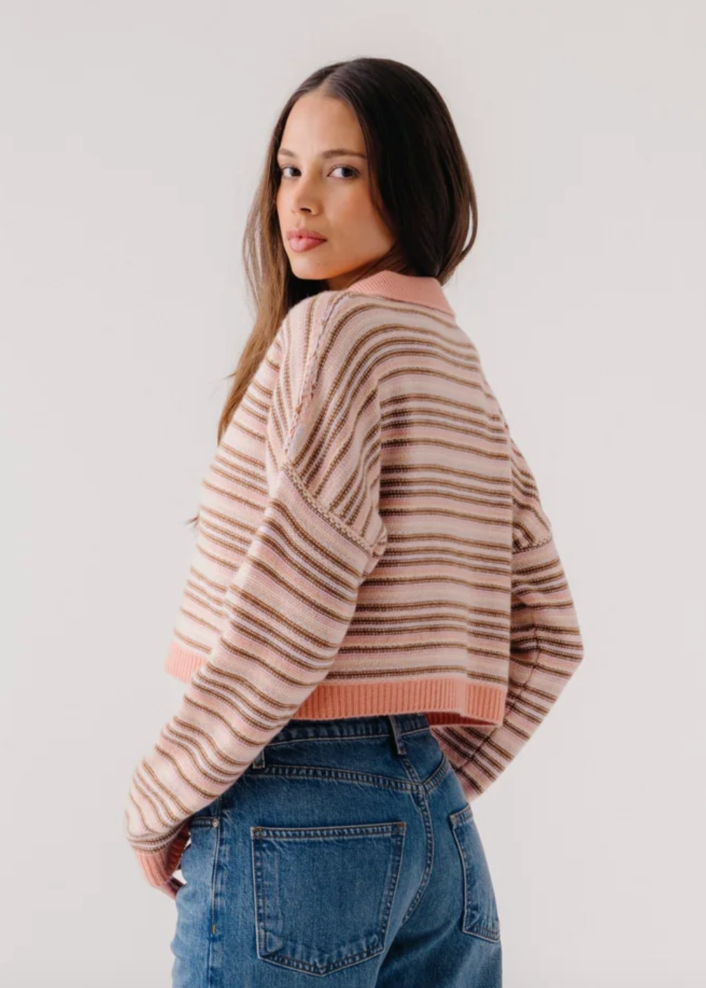 person wearing sablyn womens cashmere Maddie Long Sleeve Cropped Stripe Polo in Melon