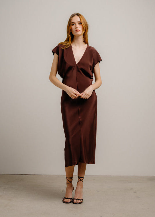 person wearing sablyn womens silk Inez Draped V-Neck Silk Dress in Cinnabar brown