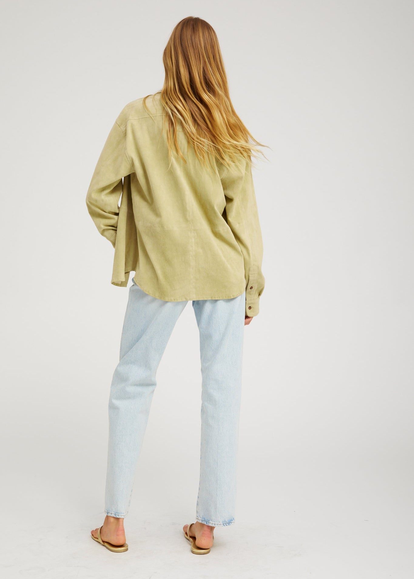 person wearing sprwmn Elise Suede Button Up Shirt in Pistachio