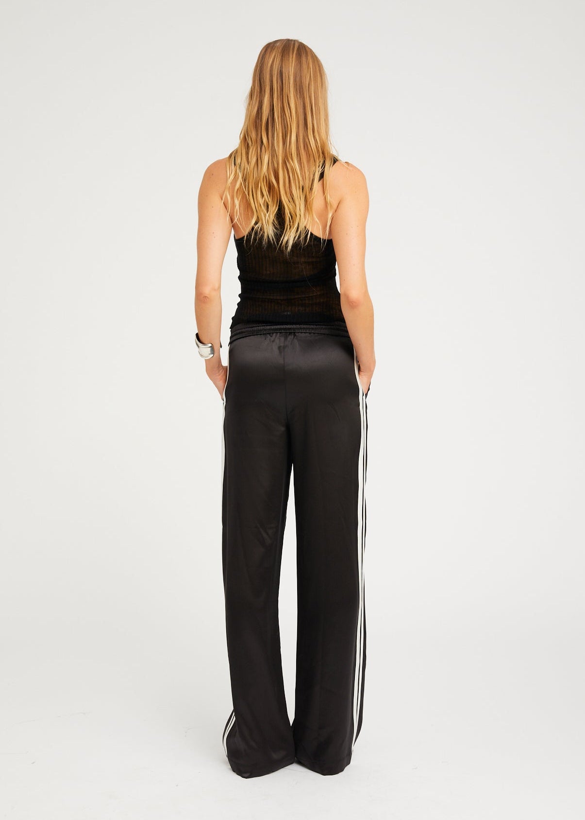 person wearing sprwmn womens Baggy Athletic Silk Pants in Black white stripe