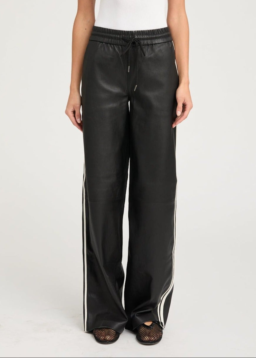 person wearing sprwmn womens Leather Baggy Athletic Stripe Sweatpants in Black