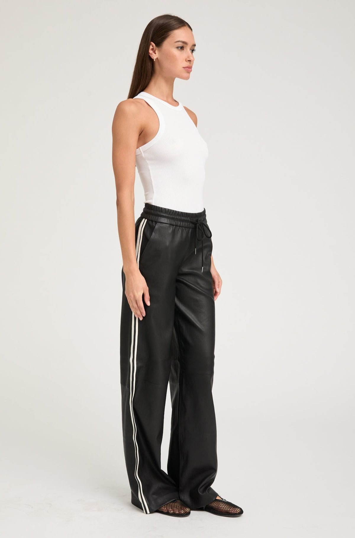 person wearing sprwmn womens Leather Baggy Athletic Stripe Sweatpants in Black