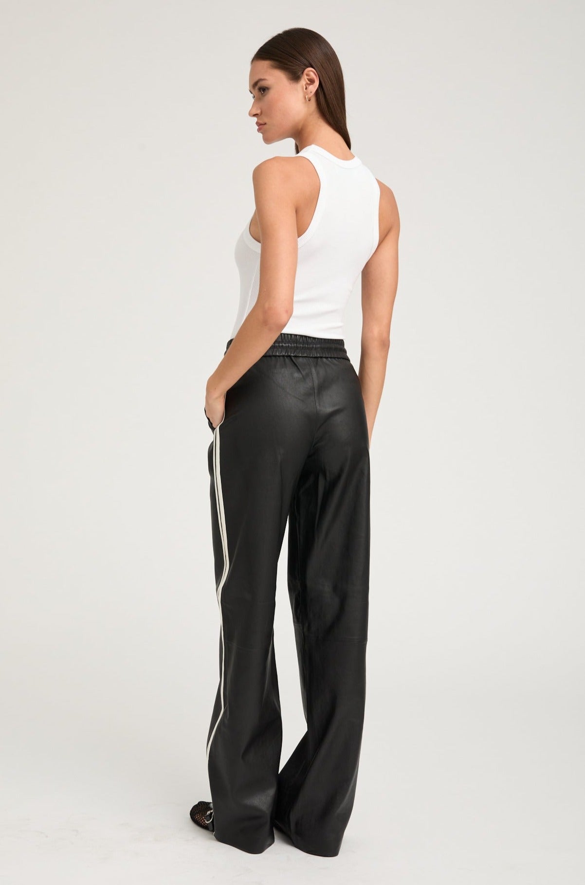 person wearing sprwmn womens Leather Baggy Athletic Stripe Sweatpants in Black